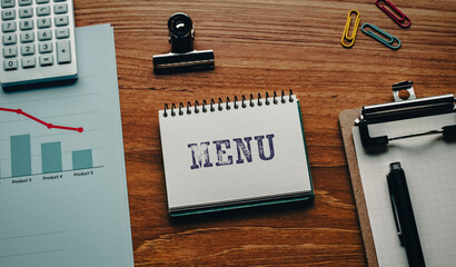 There is notebook with the word MENU. It is as an eye-catching image.