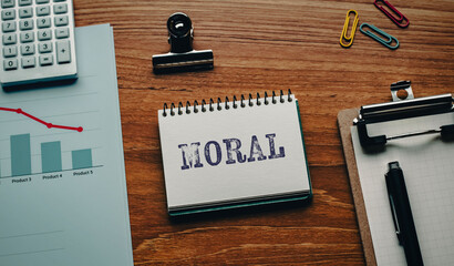 There is notebook with the word MORAL. It is as an eye-catching image.