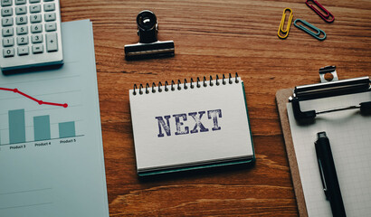 There is notebook with the word NEXT. It is as an eye-catching image.
