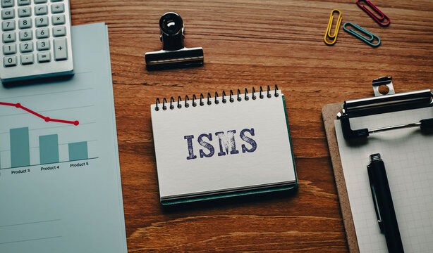 There is notebook with the word ISMS. It is an abbreviation for Information Security Management System as eye-catching image.