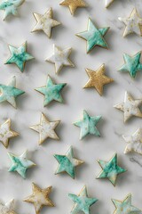 Obraz premium Star-shaped cookies, white and teal icing, gold accents, on marble