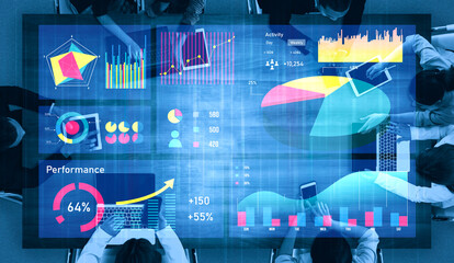 A diverse business team collaborates over digital data and charts in a modern office setting, focusing on performance analysis and strategic growth. Impute