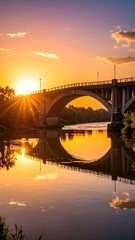 Sunlit Bridge Reflected in Calm Water Under Bright Sky at Sunset