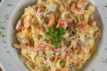 Creamy Seafood Fettuccine Alfredo with Shrimp, Calamari, and Parmesan