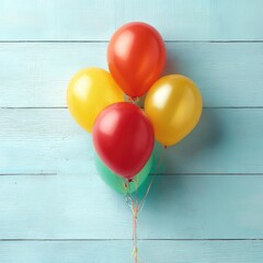 A colorful bunch of inflated balloons against a textured, light-blue wooden background