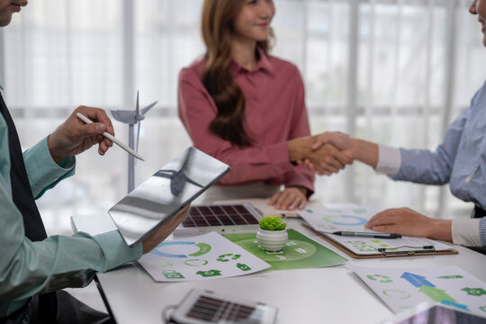 Business partners shaking hands for renewable energy deal - Powered by Adobe