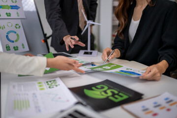 Business team analyzing esg, sustainability, and green energy reports