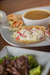 Close-up of a Traditional Stuffed Gordita with Fresh Cheese and Salad