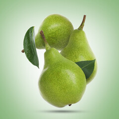 Fresh green pears flying in air on color background