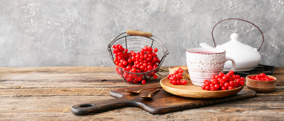 Cup of healthy viburnum tea on table