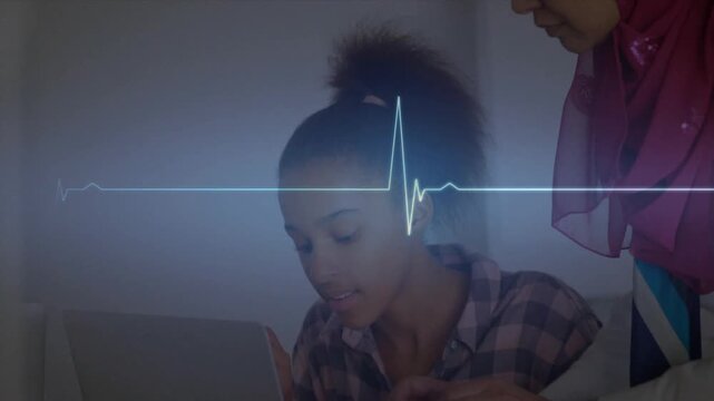 Mother guiding daughter typing on laptop wiring circuit as heartbeat waveform guiding STEM learning