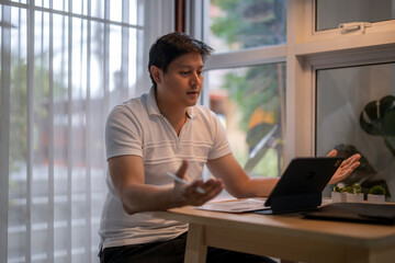 Asian freelancer having video conference at home office