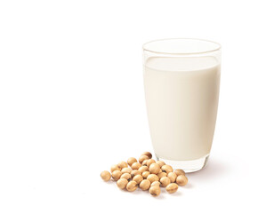 Glass of soy milk and soybeans on white background.