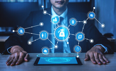 A businessman interacts with a futuristic holographic interface showcasing various icons reflecting financial and technological concepts in a modern office environment. Tessel