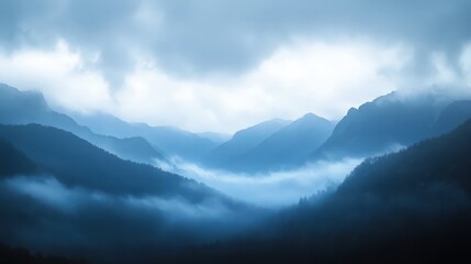 Obraz premium A misty mountain range under an atmospheric sky, conveying vastness and mystery.
