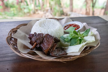 Grilled Beef Ribs with Rice and Fresh Salad. Sizzling Beef Ribs Plate with Rice and Spicy Sauce....