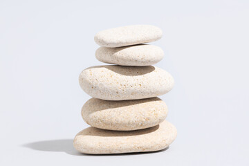 Stack of pebbles on grey background. Zen concept