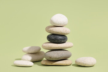 Stack of pebbles on green background. Zen concept