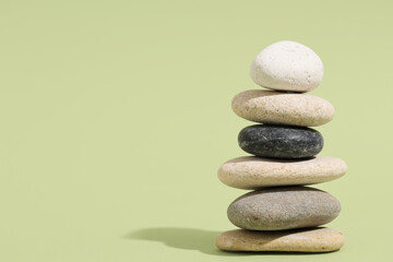 Stack of pebbles on green background. Zen concept