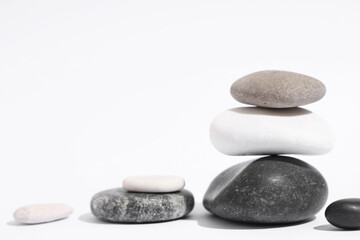 Stack of pebbles on light background. Zen concept
