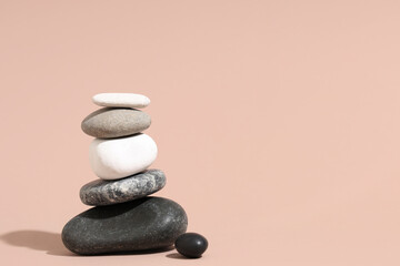 Stack of pebbles on beige background. Zen concept