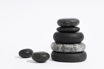 Stack of pebbles on light background. Zen concept