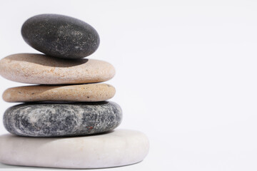 Stack of pebbles on light background. Zen concept
