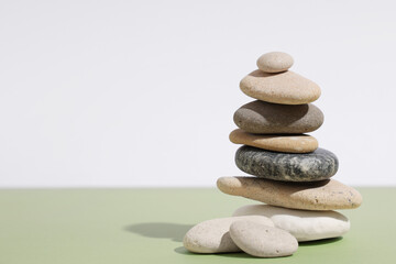 Stack of pebbles on color background. Zen concept