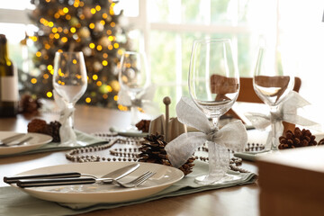Christmas table setting with fir cones in kitchen, closeup