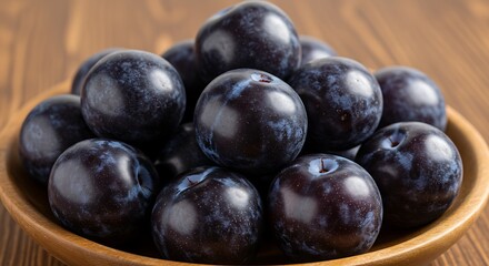 Fototapeta premium Delicious and Juicy Plums in a Wooden Bowl, Perfect for a Healthy Snack and Dessert Delight