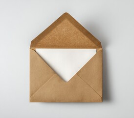 Top-down shot of a brown paper envelope opened, revealing a white card on a white backdrop