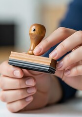 Holding wooden stamp with rubber layers, ready to authenticate documents