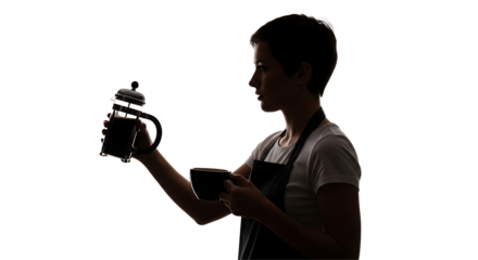 Silhouette of a young man wearing an apron holding a professional camera and looking at its screen in a dark studio setting