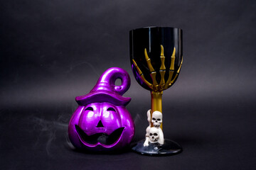 Halloween-themed decorations featuring a purple pumpkin and a skeleton goblet. perfect for adding a spooky touch to your festive celebrations.