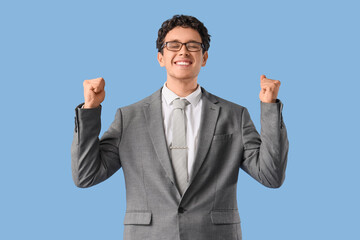 Dreaming young businessman on blue background