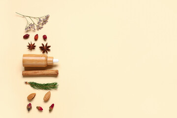 Composition with bottle of essential oil, anise stars, dried flowers and cinnamon stick on yellow background