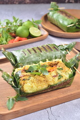 Grilled rice with chicken,  wrapped in banana leaves, traditional Indonesian food