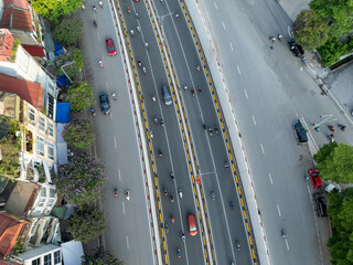 Overhead aerial view of Xa Dan street in Hanoi with cars and motorbikes in traffic.