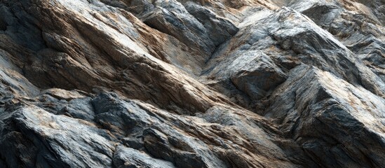 Close-up of layered, textured rock face. Natural light highlights varying shades of gray and brown
