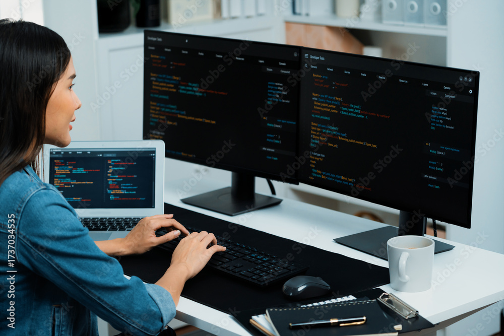 Wall mural young asian in it developer creating with typing online information on pc with coding program data o