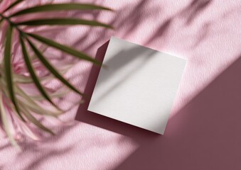 Square white card with shadows and pink fabric, greenery in the corner, well-lit