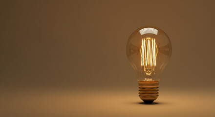 Vintage lightbulb with glowing filament on a sepia background, idea concept