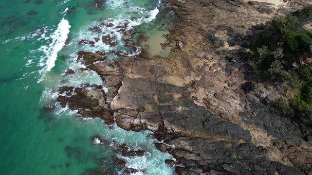 Rocky Coastline And Sea Waves In Coolum Beach, Queensland, Australia. - aerial shot
