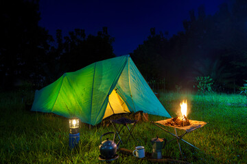 Night camping in a forest with a tent under the stars