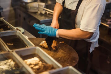 chopping roasted chicken for serving