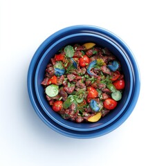 Nested blue bowls filled with a colorful mix of cooked meat, vegetables