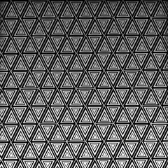 Abstract seamless geometric pattern texture with triangles, vector illustration, and vintage style backdrop design