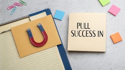 Magnetic Note with Inspiring Text on Success Next to Paper Clips and Sticky Notes on a Desk Surface