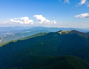 Fototapeta premium Mountain range panorama under a partly cloudy sky