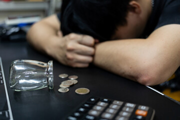 Financial Stress, Empty Jar, Few Coins, and Overwhelmed Person. financial problems, debt, money shortage, and the emotional burden of not having enough funds to cover expenses.